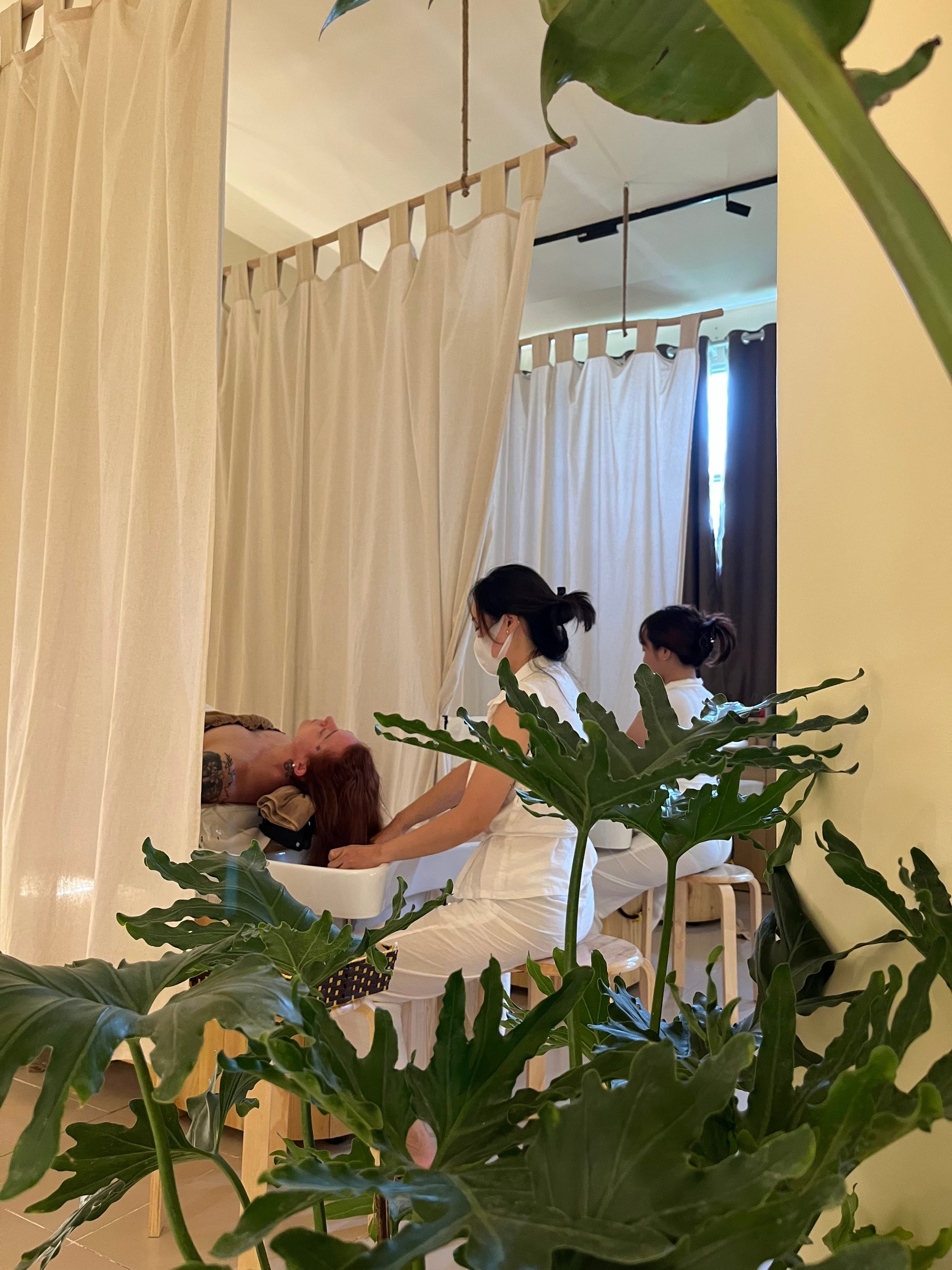 Tropi Q head spa treatment room — warm lighting and tropical decor